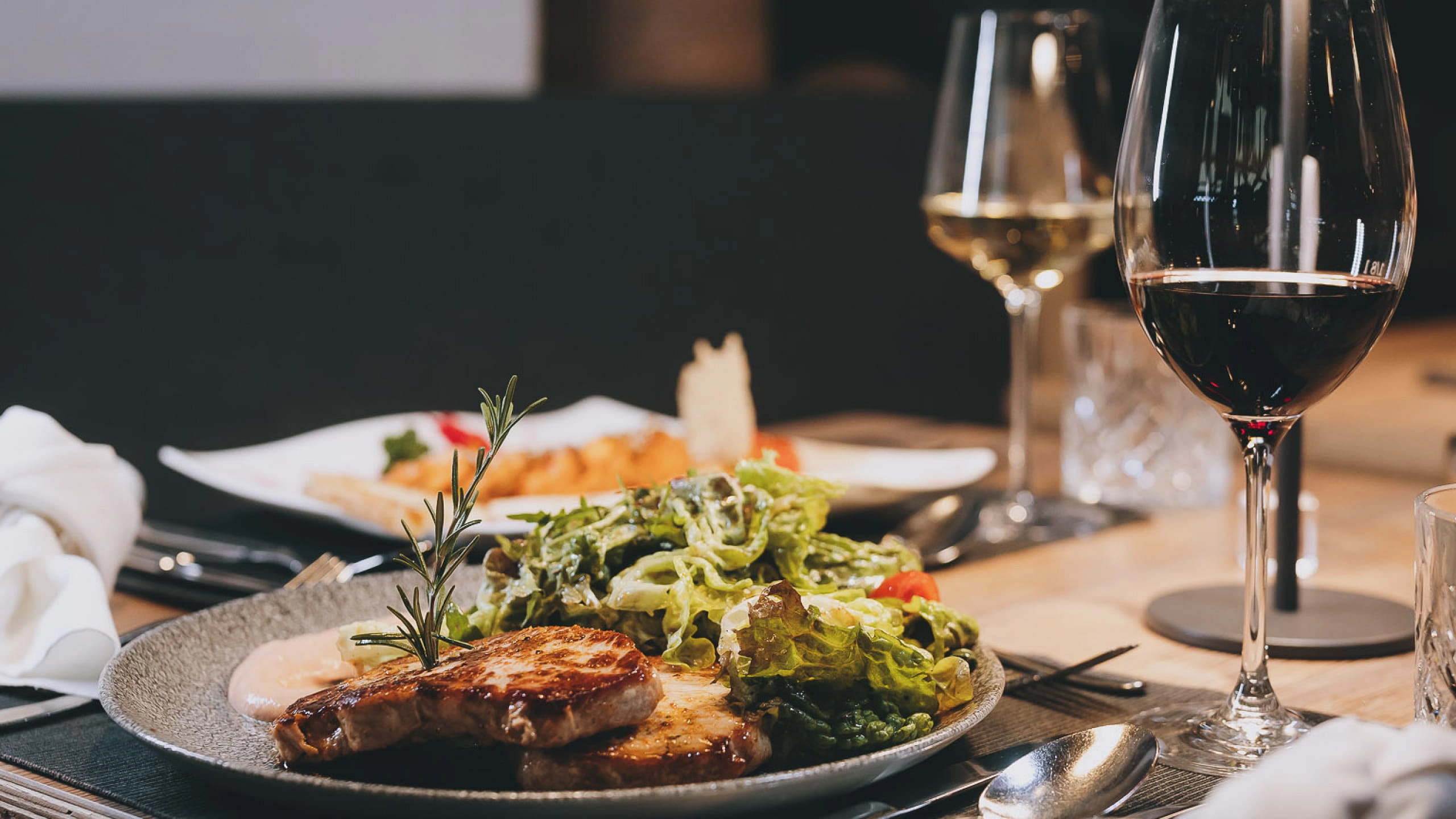 A plate with grilled meat and salad at a restaurant.