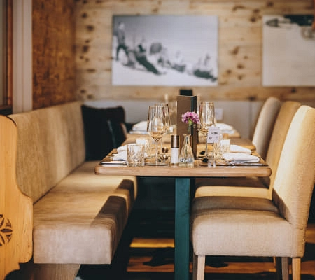 Gemütliches Restaurant mit Holzwänden und gedecktem Tisch.