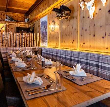 Cozy dining area with wooden decor and set table in Gollinger Restaurant