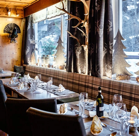 Rustic restaurant with a set table and hunting decor.