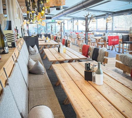 Cozy restaurant interior with wooden tables and seating
