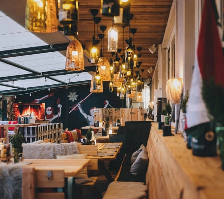 Cozy terrace with wooden seating areas and atmospheric lighting.