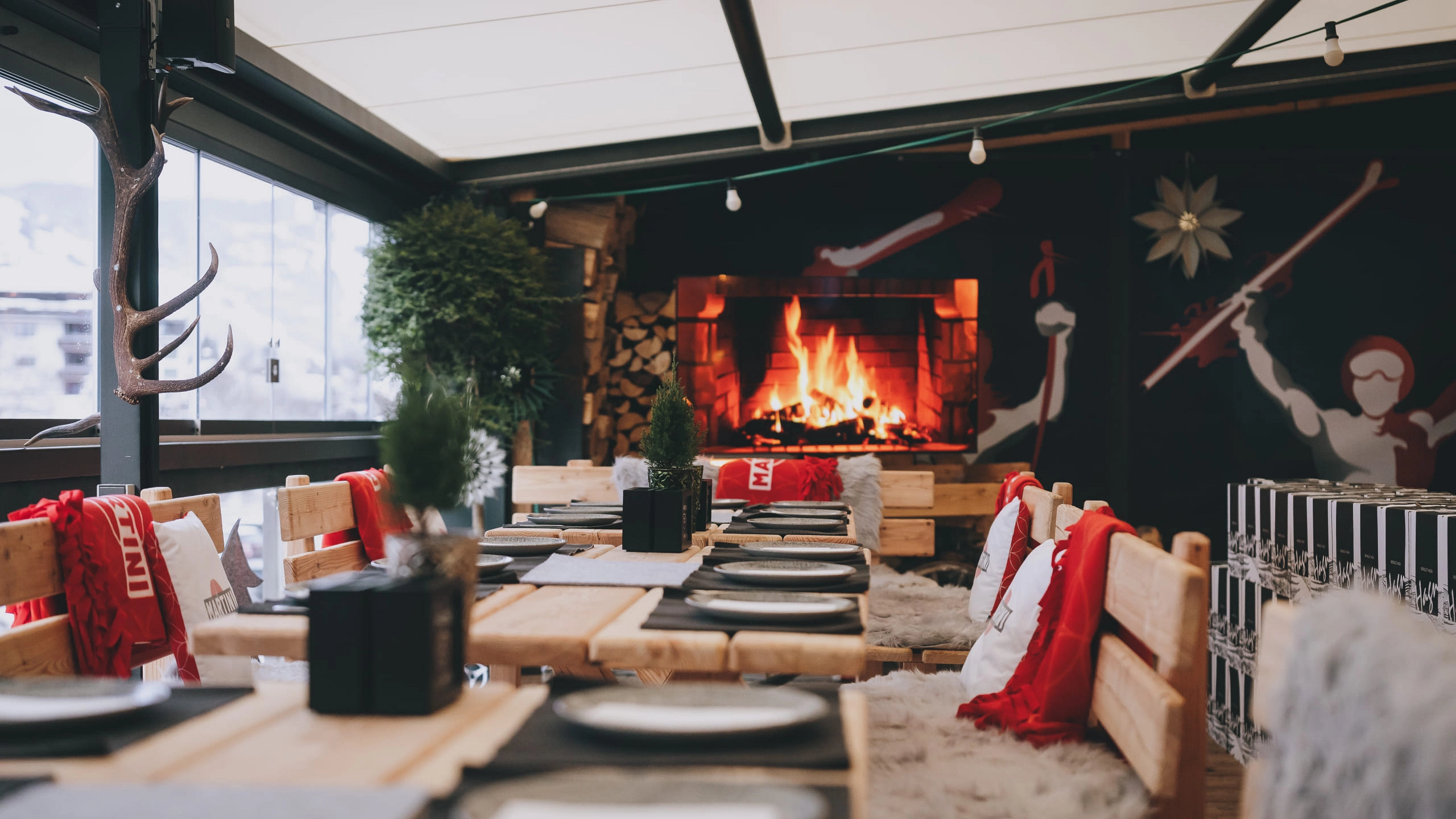 Cozy interior view of Der Gollinger Terrace with fireplace and tables.
