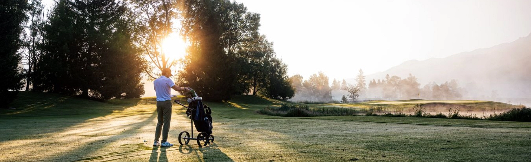 Golfspieler auf dem Platz in Zell am See bei Sonnenaufgang